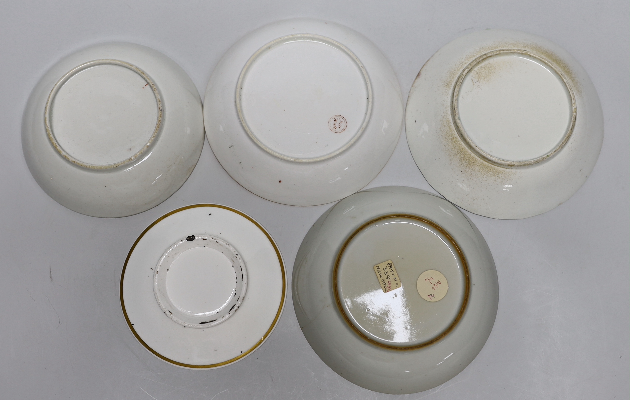 A group of early 19th century English porcelain cups and various saucers to include a Spode two handled chocolate cup and saucer (10)